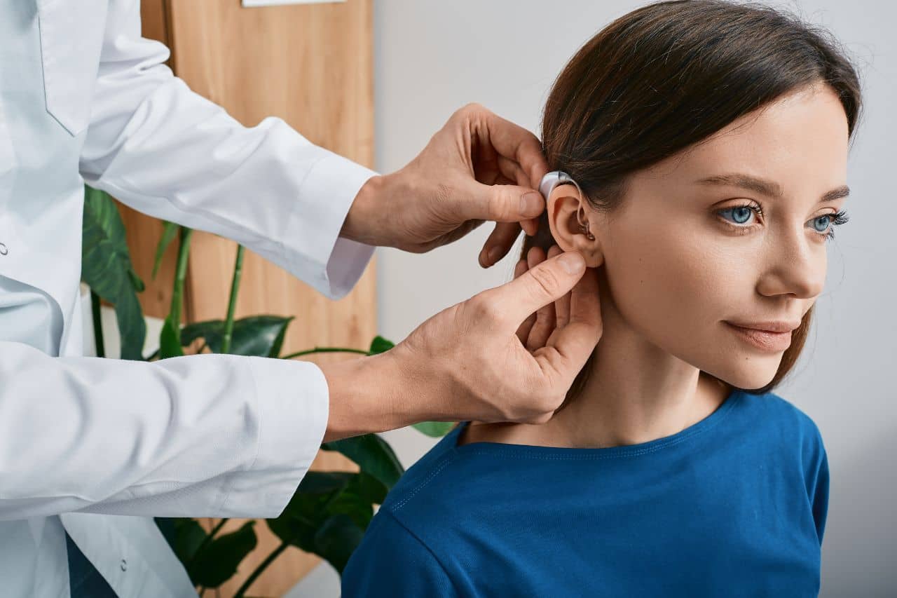 Doctor conducting hearing test with woman