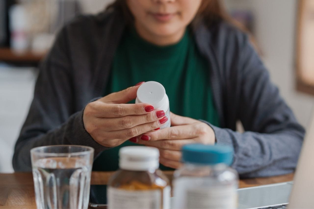 Woman looking at a pill bottle
