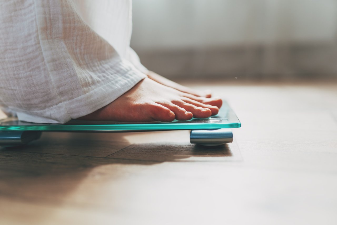 Person standing on a glass bathroom scale