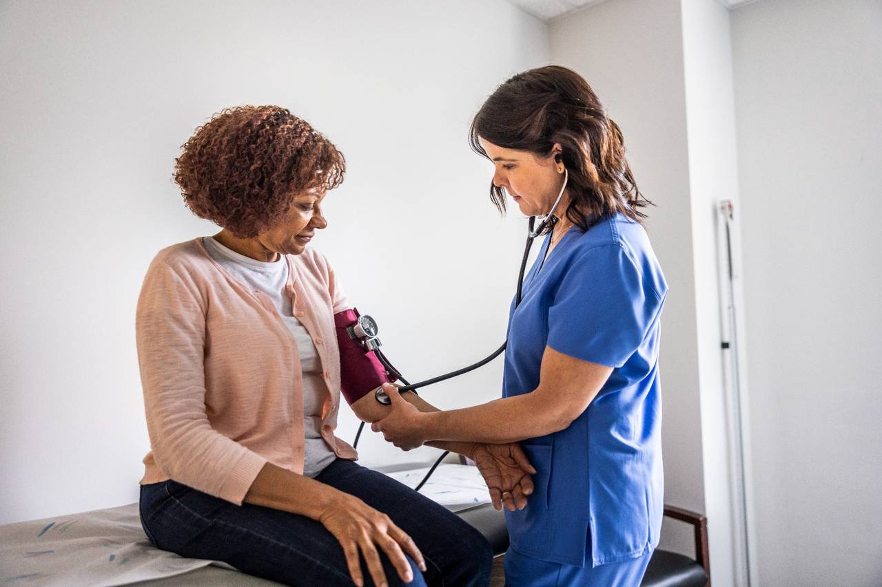	nurse checking blood pressure