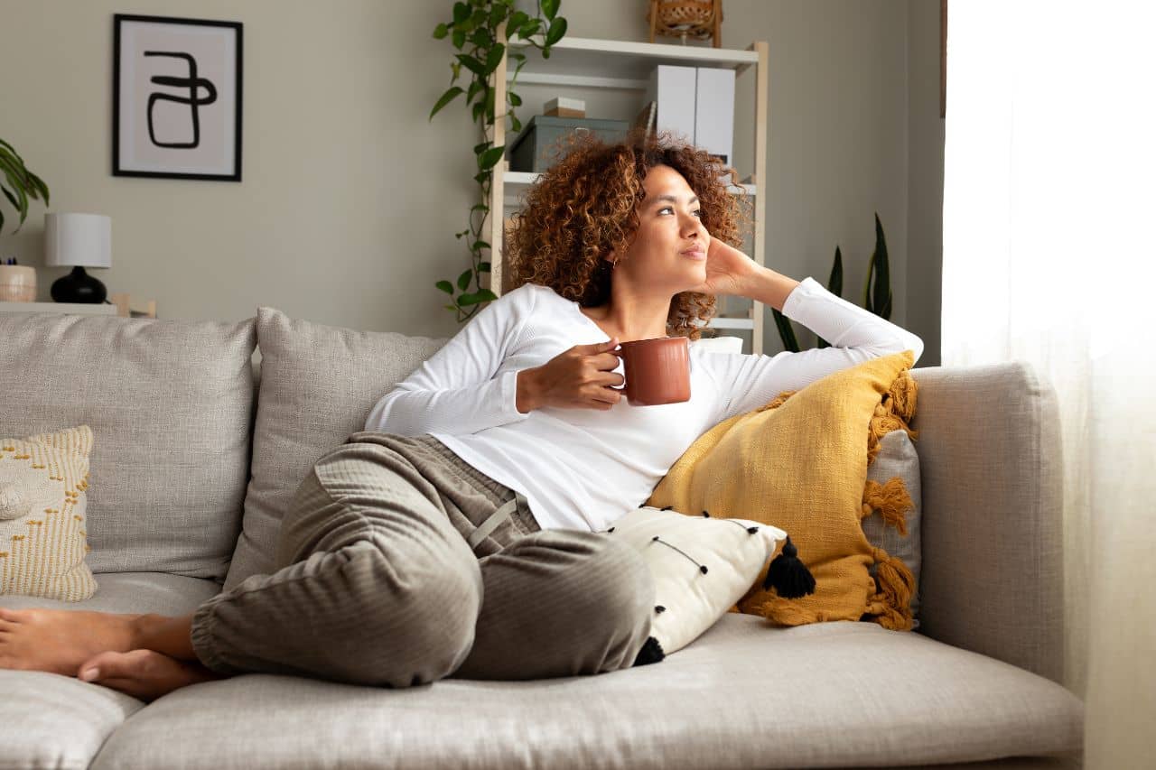 woman drinking coffee on a couch