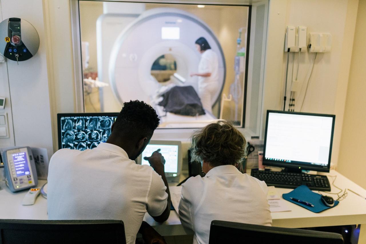 Doctors examining an MRI scan outside of a MRI room