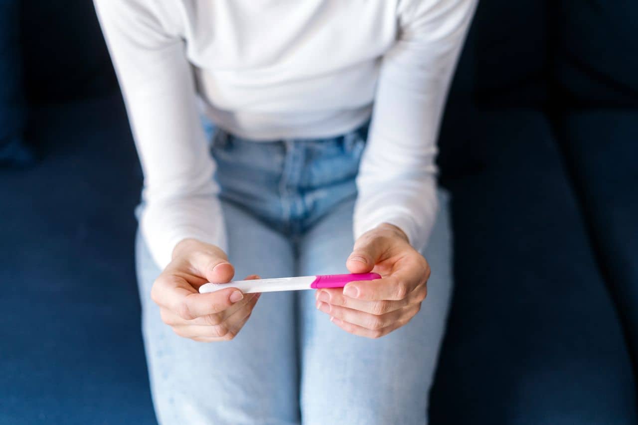 Woman holding a pregnancy test