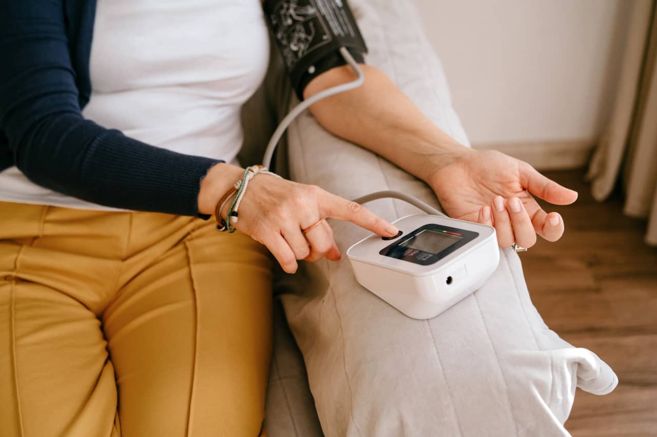 A woman checking her blood pressure