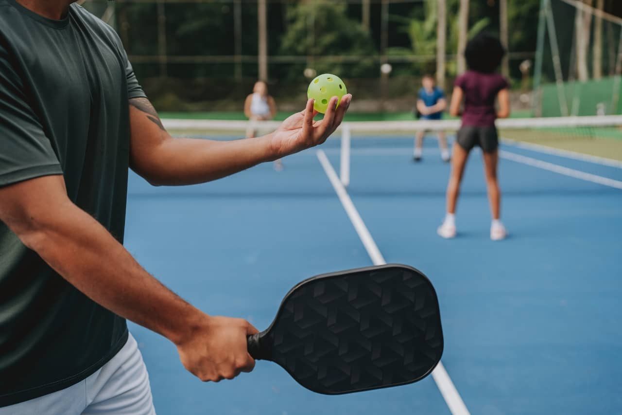 Close up of a guy playing pickleball 