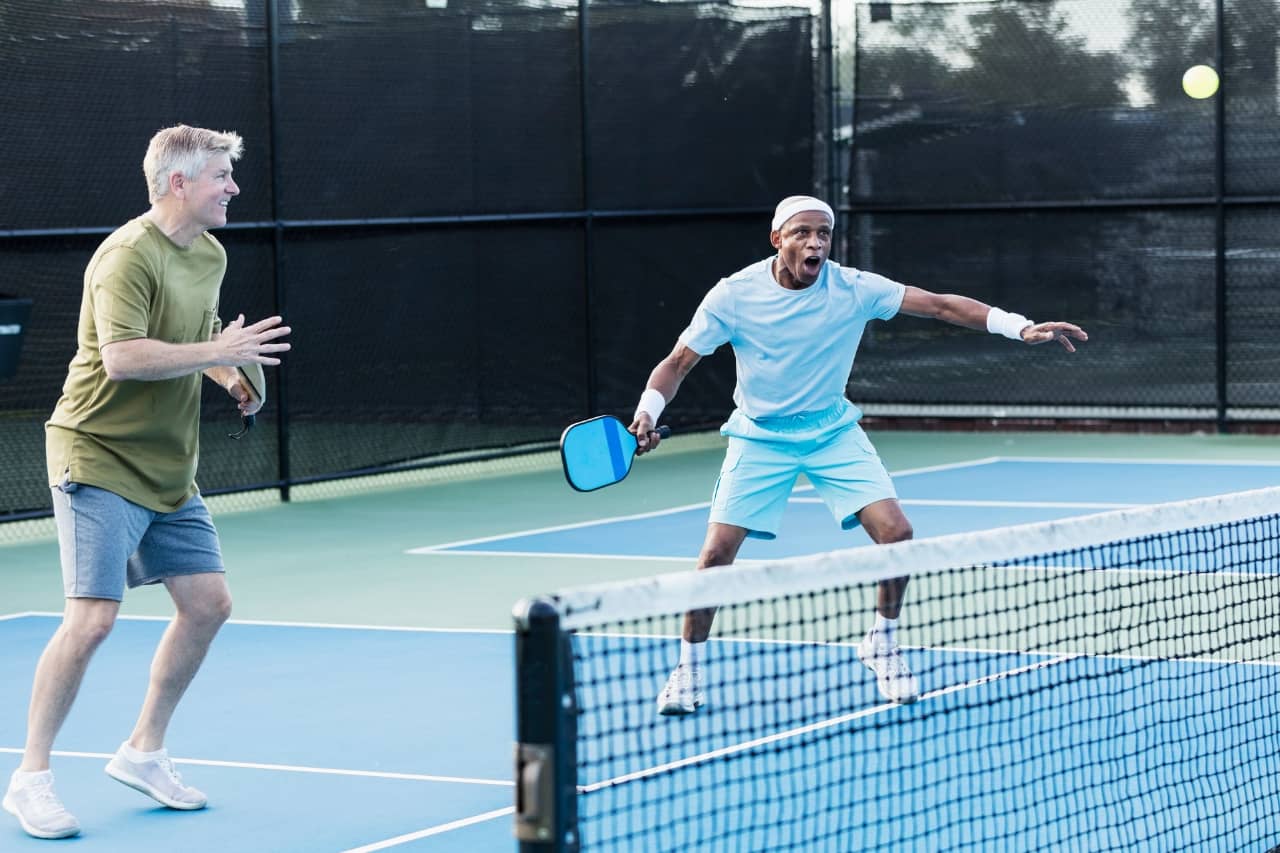 Two men on a pickleball court