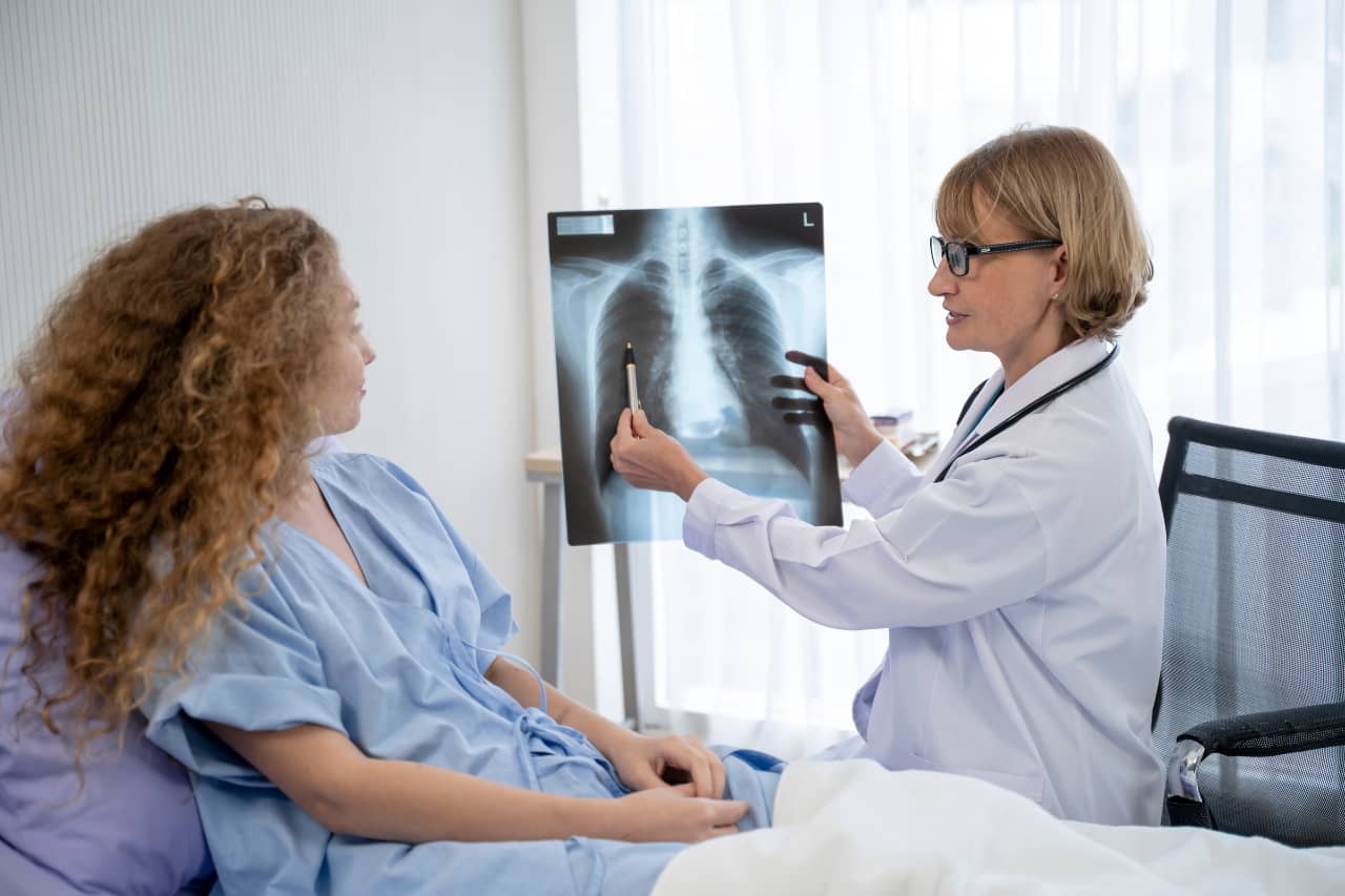 Doctor showing patient an image of her lungs