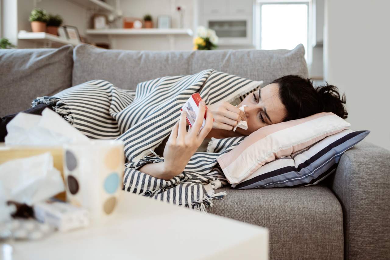 woman sick on couch