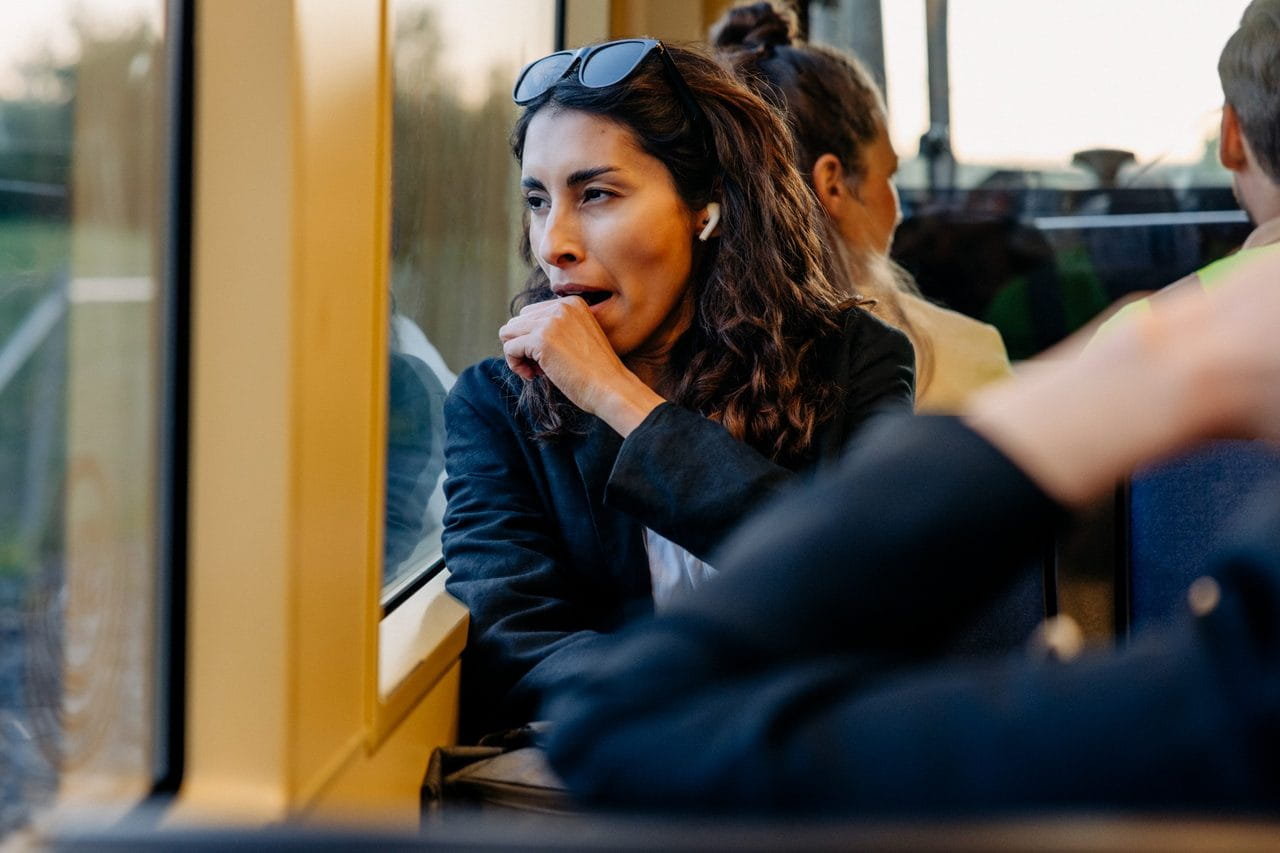 Tired woman yawning on a train