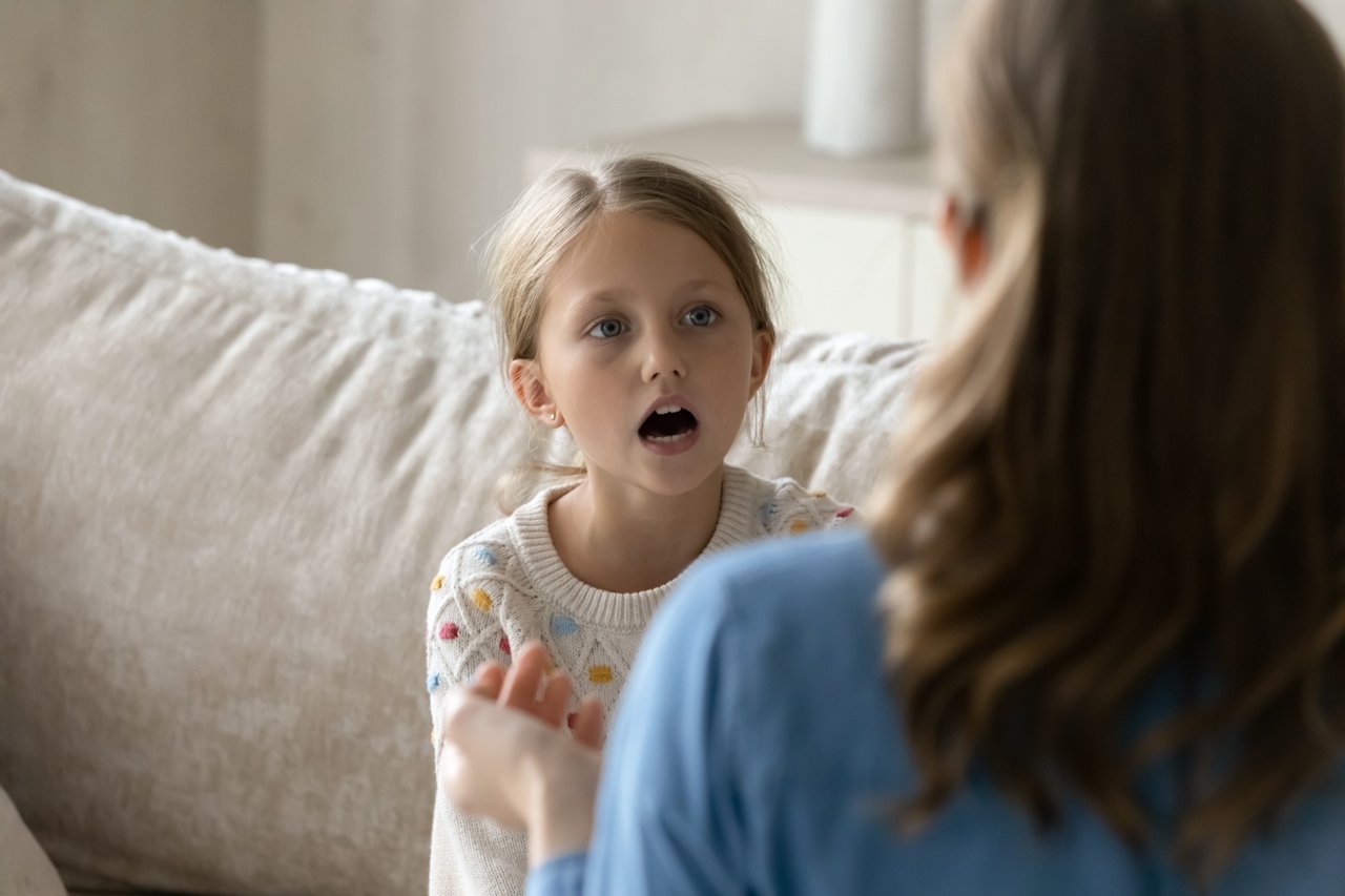 Child practicing speech during a therapy session