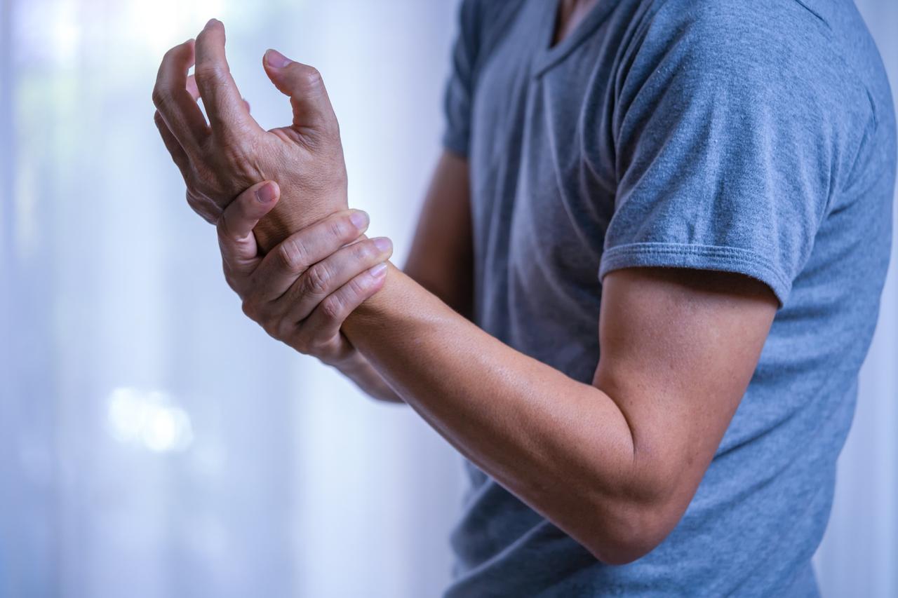 Man holding his wrist