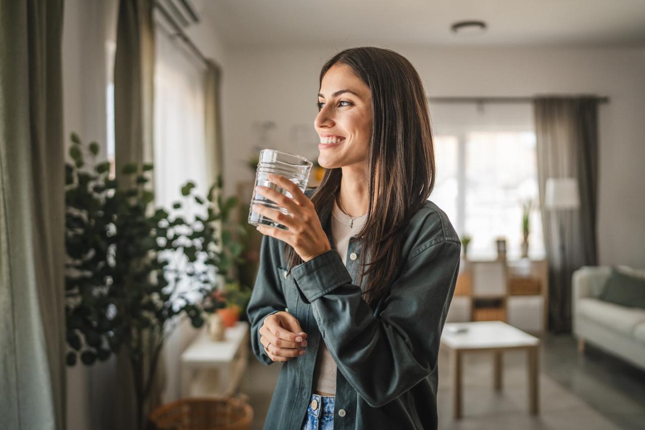 Smiling woman drinking water