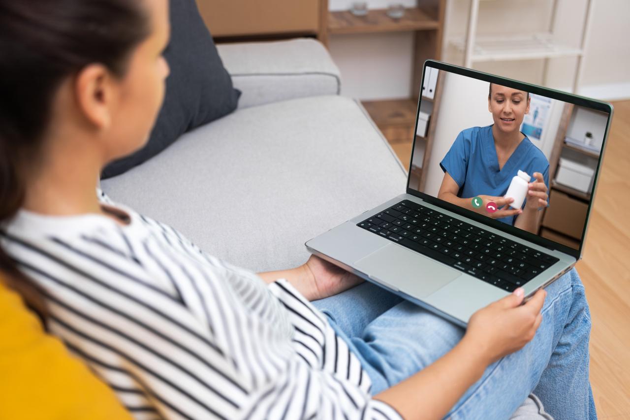 Telehealth video consult on laptop.