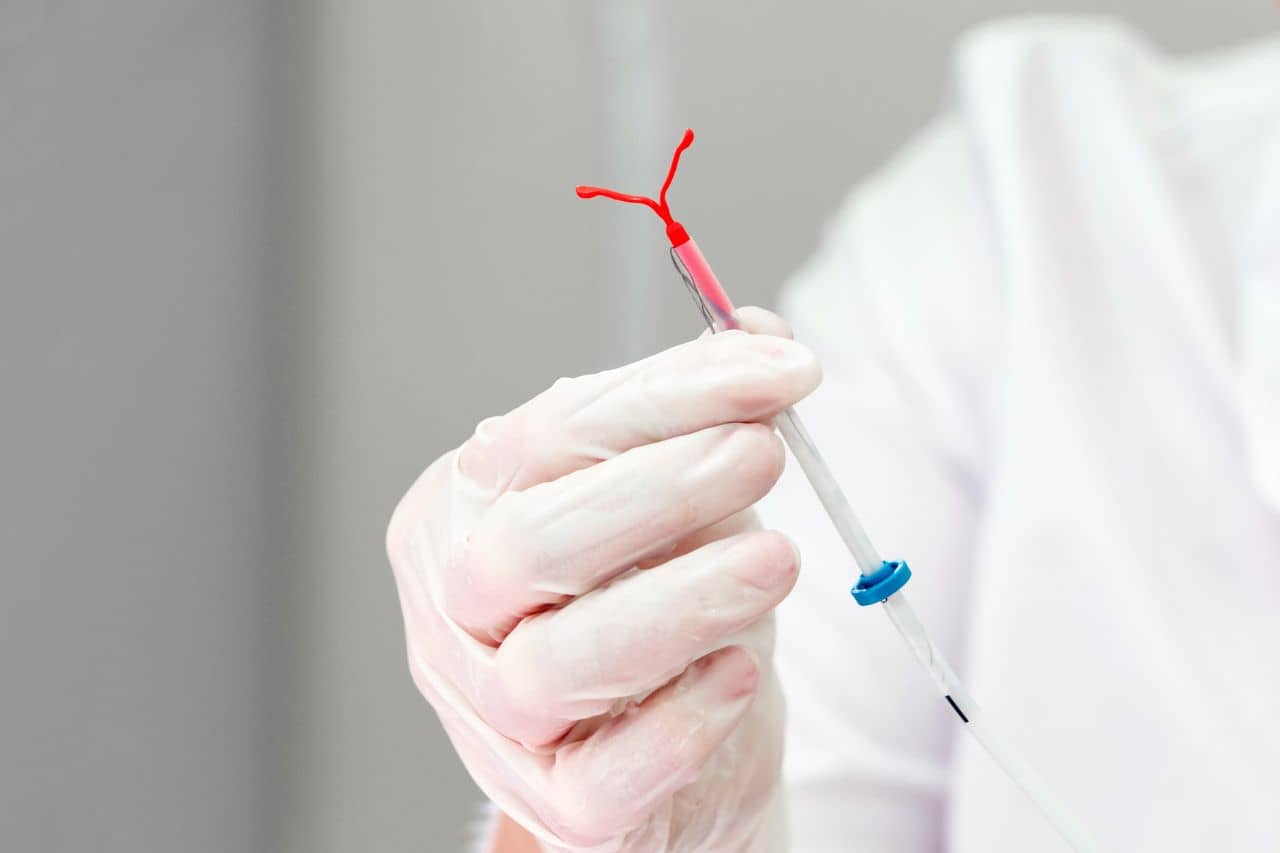 Doctor holding an IUD