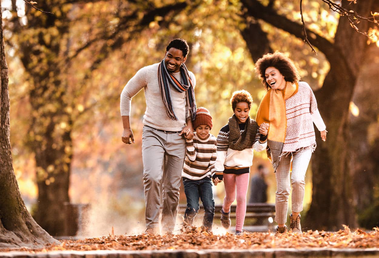 Family walking in leaves in the Fall