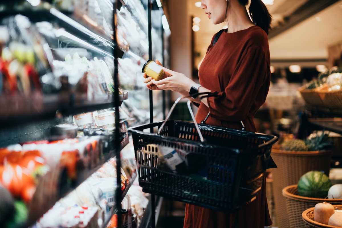 woman standing looking at fruit